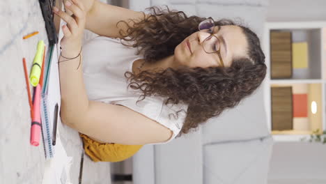 Vertical-video-of-Female-student-stressed-and-biting-her-nails.